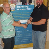 Hamburg Grange President Michael Adams presents a check for $1000 to One Wish Foundation President Jarrod Renninger. Photo Credit: Barbara Schroeder