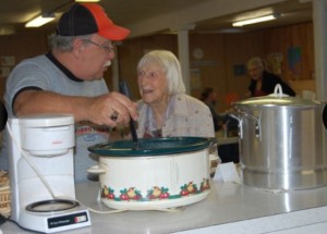 Bob Pasero, left, dishes up a steamy bowl of navy bean soup for longtime Orland resident Kay Larsen at the fourth annual Soup Bowl on Saturday.